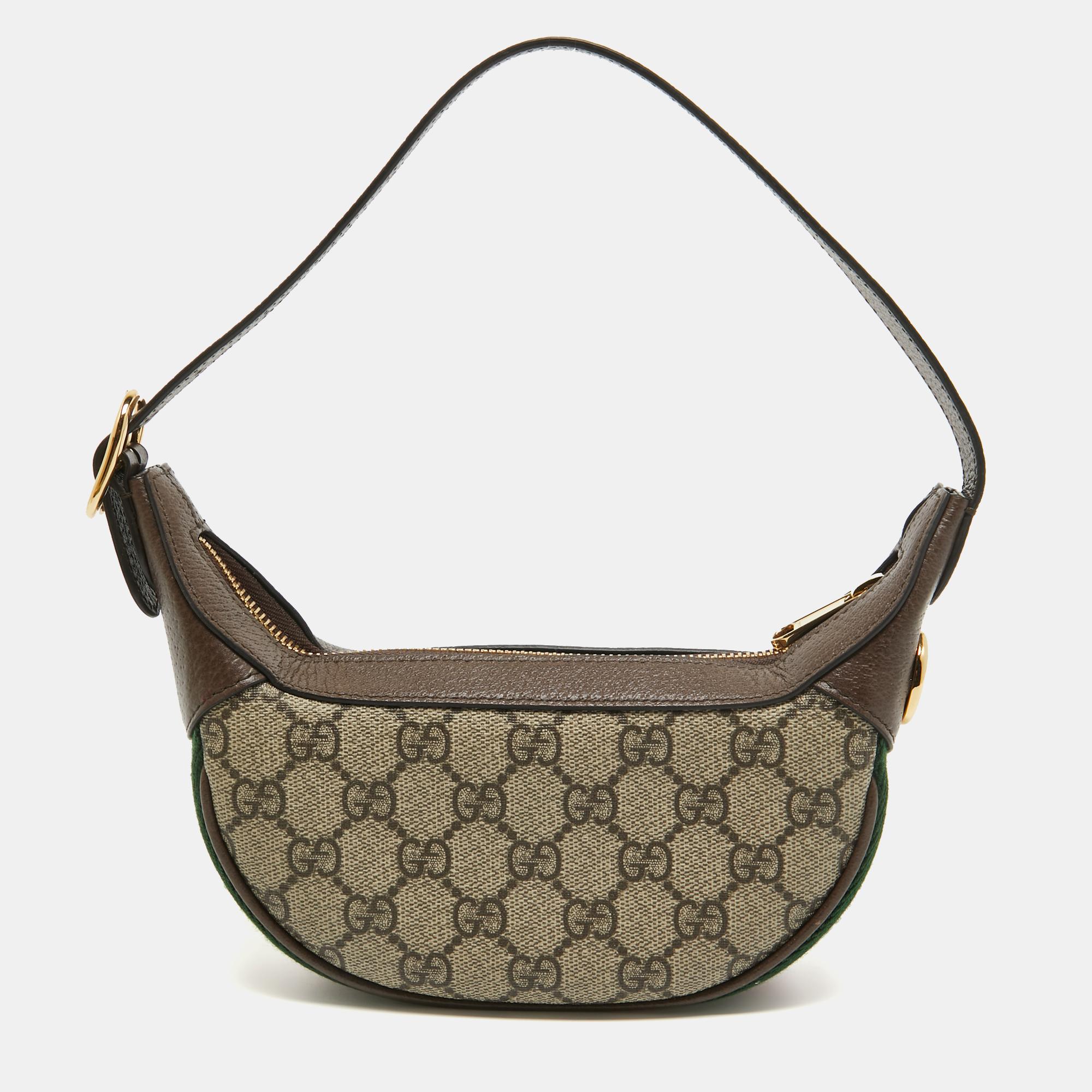 Created from the GG supreme canvas and leather, this Gucci bag is imbued with heritage details. The Web stripe detailing and the interlocked 'GG' motif on the front give it a luxe update. Lined with suede, this bag makes for a luxurious abode for