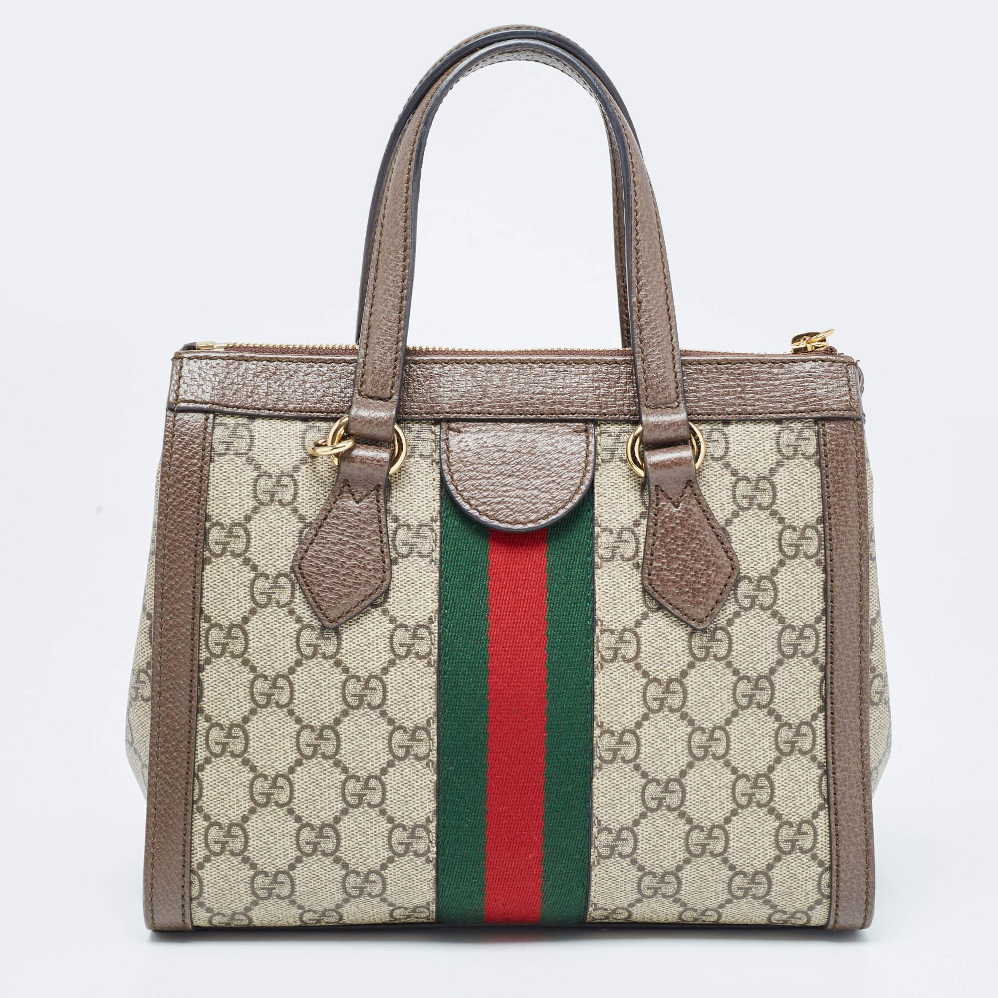 Crafted from GG Supreme canvas and leather, this Gucci Ophidia bag comes in a structured shape for a sophisticated look. It features the iconic Web stripe, and the GG motif—all Gucci codes. The bag suspends from two handles and a slender strap for