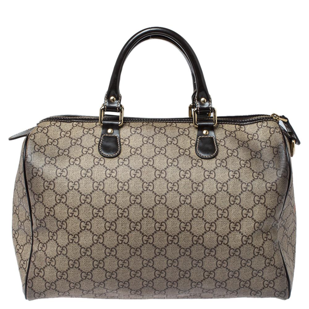 This classic Joy Boston bag by Gucci is a buy to cherish. Crafted from GG Supreme canvas and styled with leather trims, the bag has a well-sized canvas interior and two top handles for you to easily swing. The piece is complete with Tattoo Heart