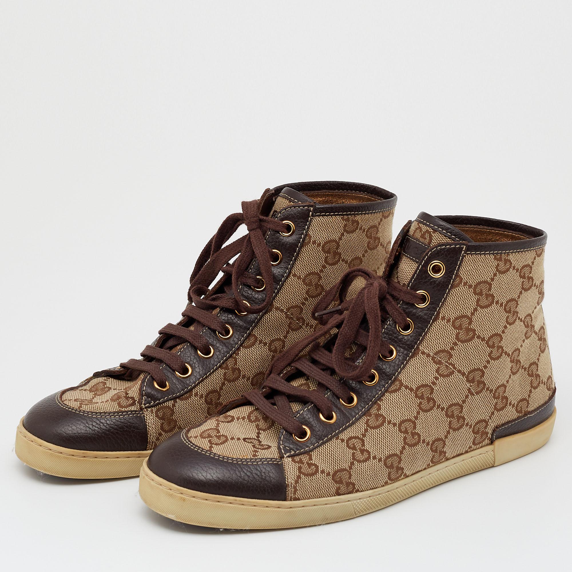 Cloak your feet with these luxuriously designed Gucci sneakers. Created from leather and GG Supreme canvas, they display lace-up vamps, rubber soles, and gold-tone hardware. This beige high-top pair will complement a variety of outfits in your