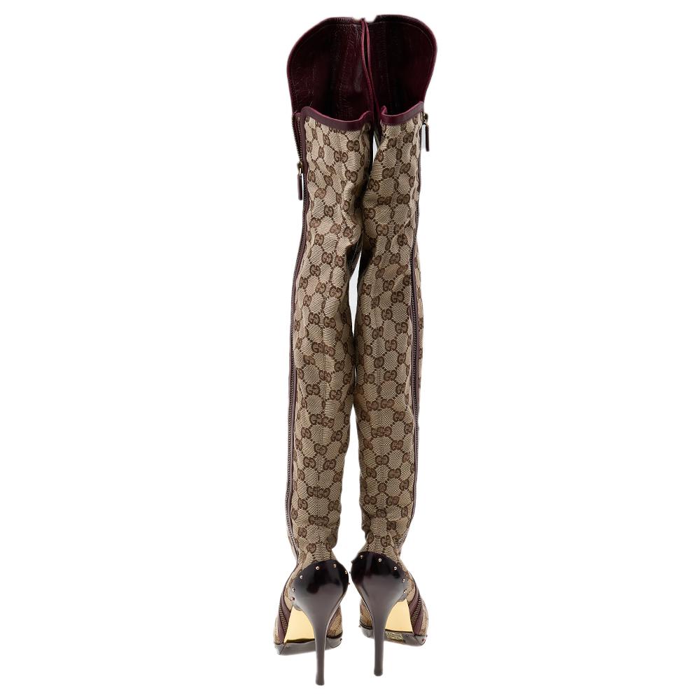 Brimming with signature charm and aesthetics, these gorgeous boots from the House of Gucci will bring the brand's skill to your closet effortlessly. They are crafted using beige-burgundy GG canvas and leather into a thigh-high silhouette. They have