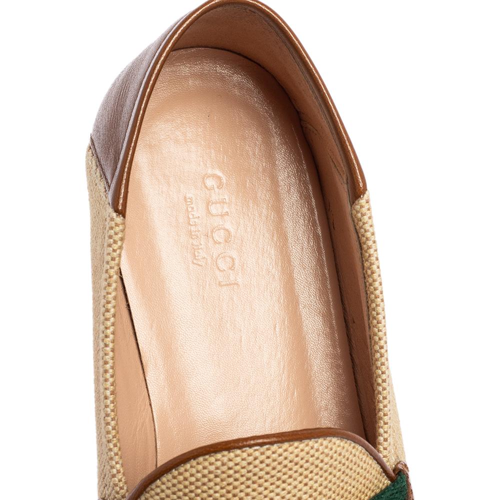 Brimming with signature details of the House, these Brixton loafers from Gucci will charm their way into your collection effortlessly. They are made from beige canvas and leather and decorated with a gold-toned Horsebit motif and Web Stripe detail