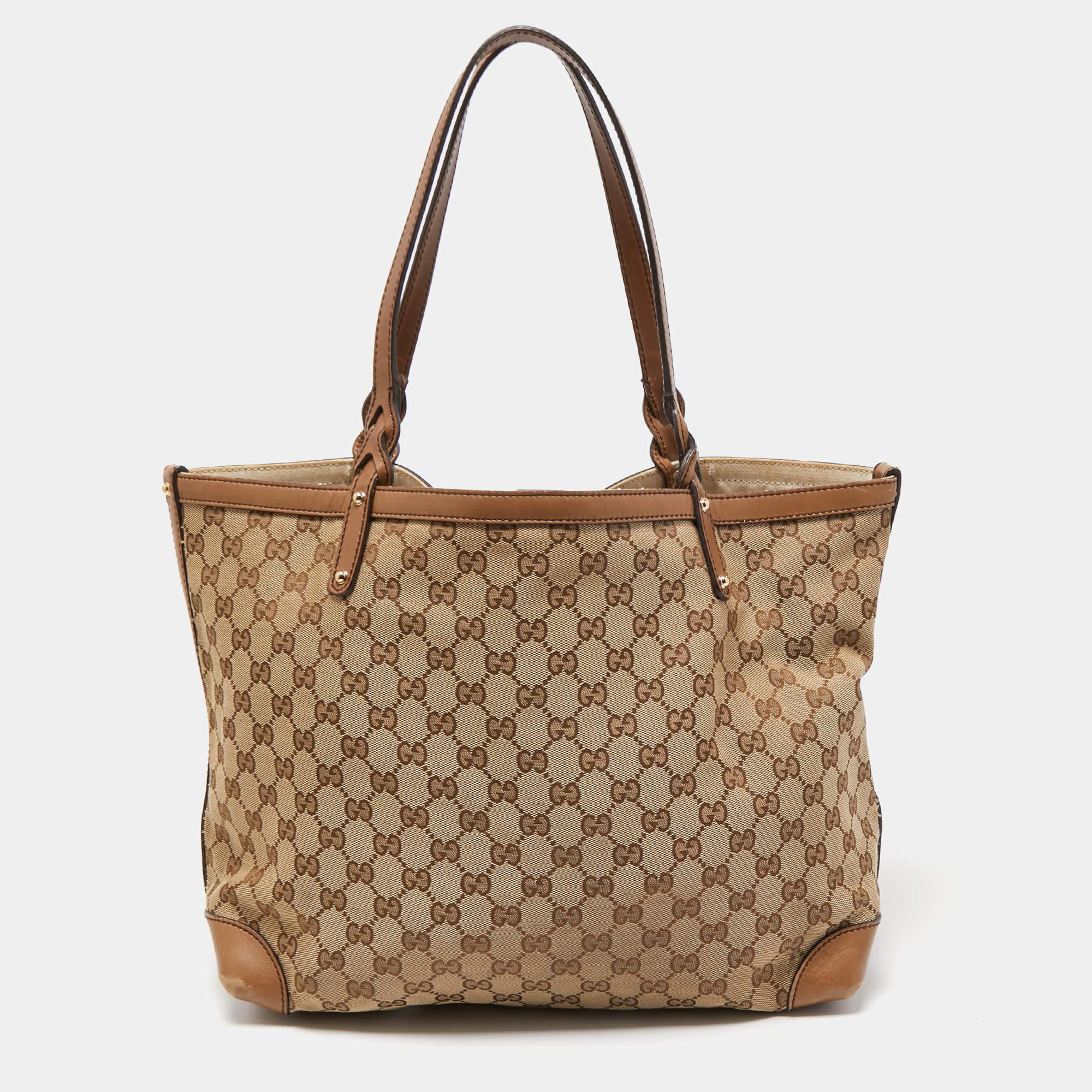 This Gucci tote is the ideal everyday bag. Made from canvas, its brown leather trim is matched with gold-tone hardware and a push lock closure. Its spacious design is lined with canvas and and comes with a matching leather pouch.

Includes:
