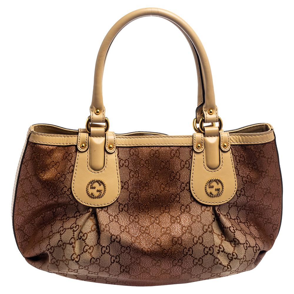 It’s hard not to be attracted to this Gucci Scarlett tote which has been crafted in GG canvas and leather trims. The exterior of the bag features double handles and GG stud detailing in gold-tone metal. The snap closure opens to a roomy canvas-lined