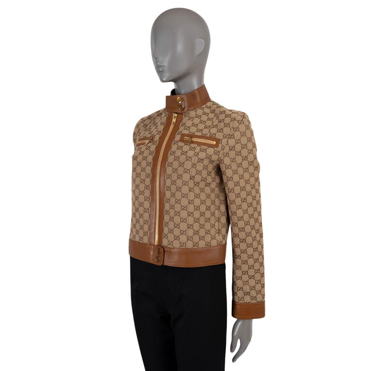 100% authentic Gucci jacket in beige and ebony GG monogram jacquard cotton (70%) and polyester (30%). Features cognac brown leather trims, band collar with snap buttons, zipper chest pockets and buttoned zipper cuffs. Closes with a zipper and