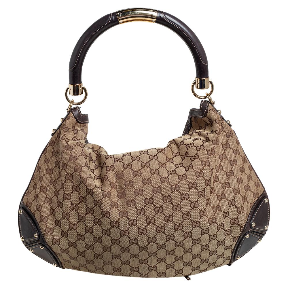 This Gucci Babouska Indy creation might just become the most loved classic bag in your closet. Crafted from GG canvas and leather, it has gold-tone hardware and the signature tassel detail at the front. The bag is equipped with a single handle, a