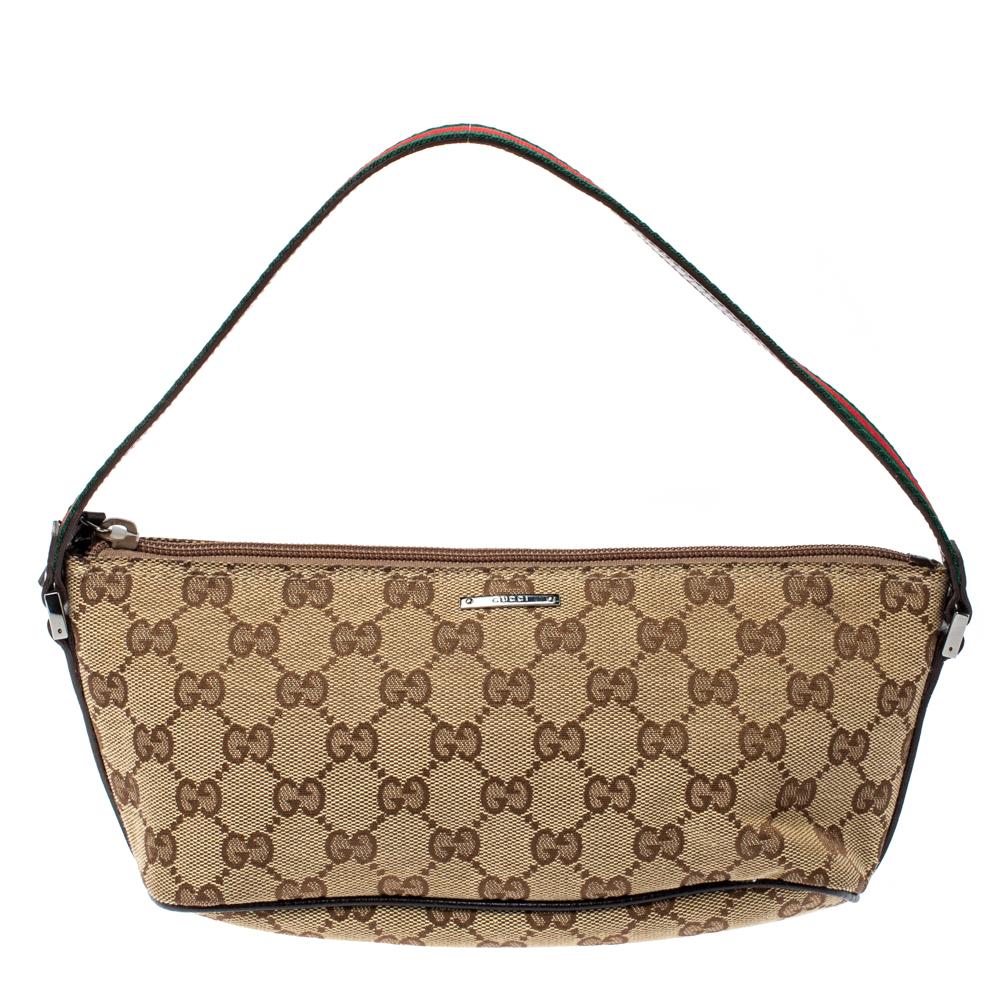 This handy boat-shaped Pochette bag is from the house of Gucci. It has been crafted in Italy and made from signature GG canvas and leather. It comes in beige & brown hues. It is equipped with a fabric interior which will house the essentials you