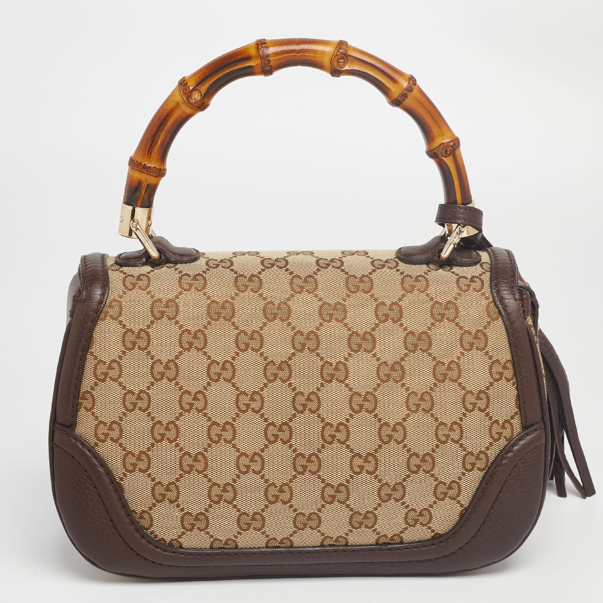This Gucci bag combines style and elegance into the ultimate everyday bag. Crafted in Italy, it is made from GG canvas and quality leather and comes in lovely shades. It is accented with a signature bamboo top handle. Secured with a bamboo turn-lock