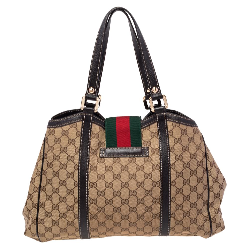 A handbag should not only be good-looking but also durable, just like this pretty New Ladies Web tote from Gucci. Crafted from the signature GG canvas in Italy, this gorgeous number has the web detail as the flap and it opens up to a spacious