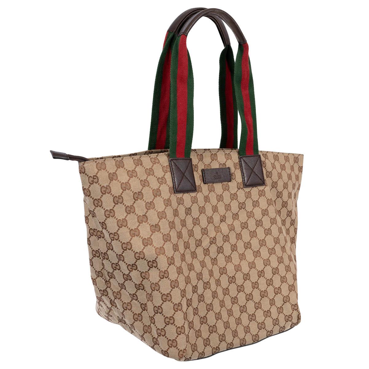 100% authentic Gucci Medium Web tote bag in beige and brown GG monogram canvas with signature Web stripe in green and red and dark brown leather trim. Opens with a zipper on top and is lined in dark brown canvas with one zipper pocket against the
