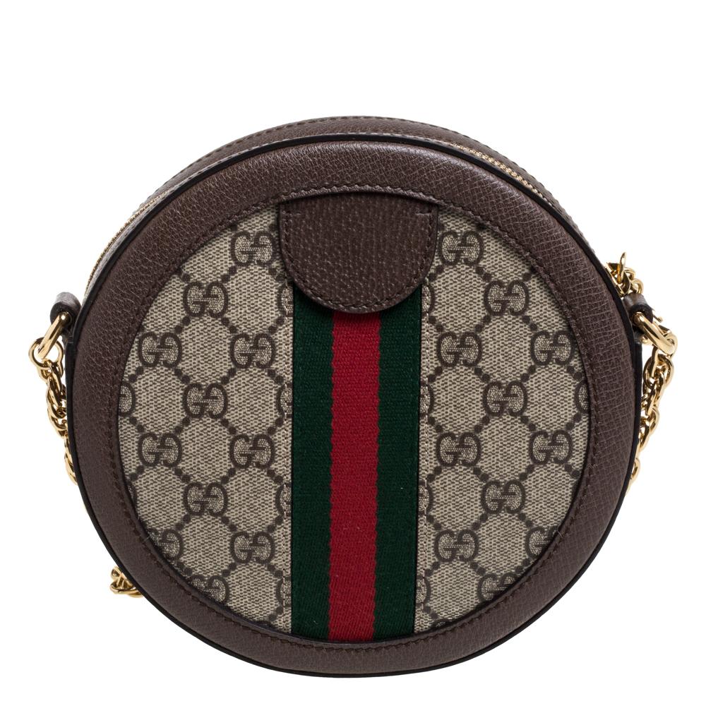 Gucci's Ophidia shoulder bag is chic creation that comes in a round silhouette. Crafted from GG Supreme canvas and leather, it is adorned with the iconic House codes- the GG logo and the Web stripes. Hold it by the slender chain-leather strap and