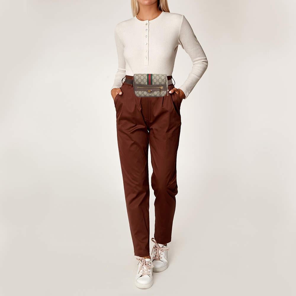 Every creation from Gucci is noteworthy for its timeless charm and versatile design. Created from GG Supreme canvas and leather  this Gucci Ophidia belt bag is imbued with heritage details. The Web stripe detailing and the branded motif on the front
