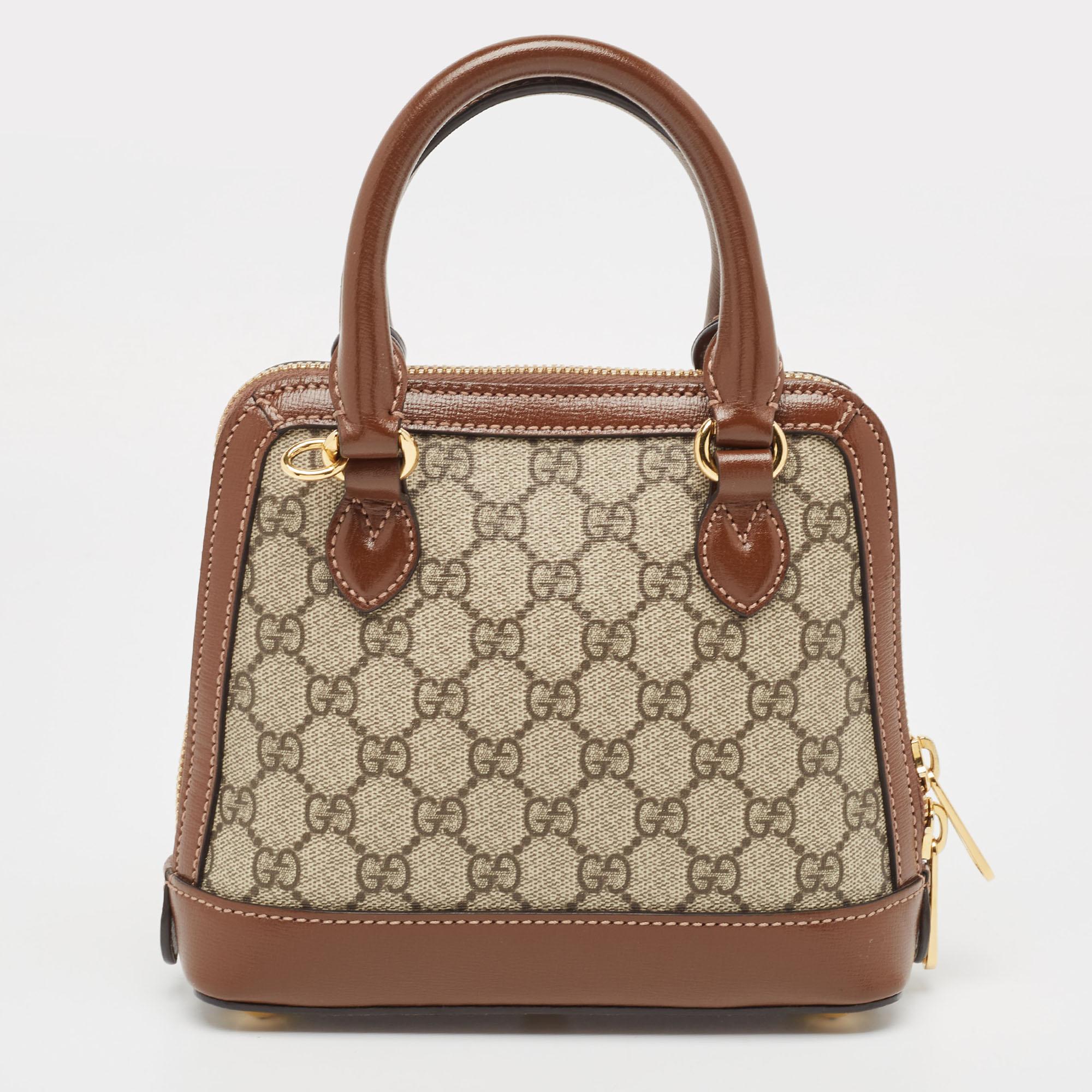 The Gucci Horsebit 1955 Top Handle Bag is a timeless marvel of craftsmanship. Its iconic GG Supreme canvas, accented with the signature horsebit detail, exudes sophistication. Compact yet spacious, it effortlessly blends style with functionality,