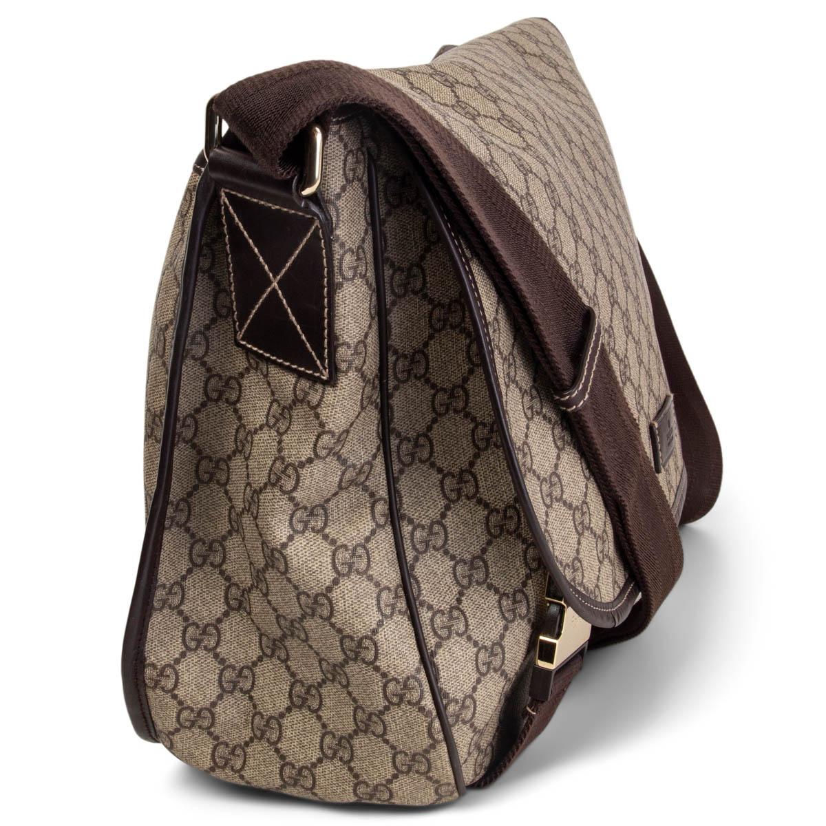 100% authentic Gucci GG Supreme brown and beige monogram coated canvas with a long adjustable cross-body nylon shoulder with leather trim. Bag comes with a bog zipper pocket on the back. The front flap opens to a brown fabric interior with one open