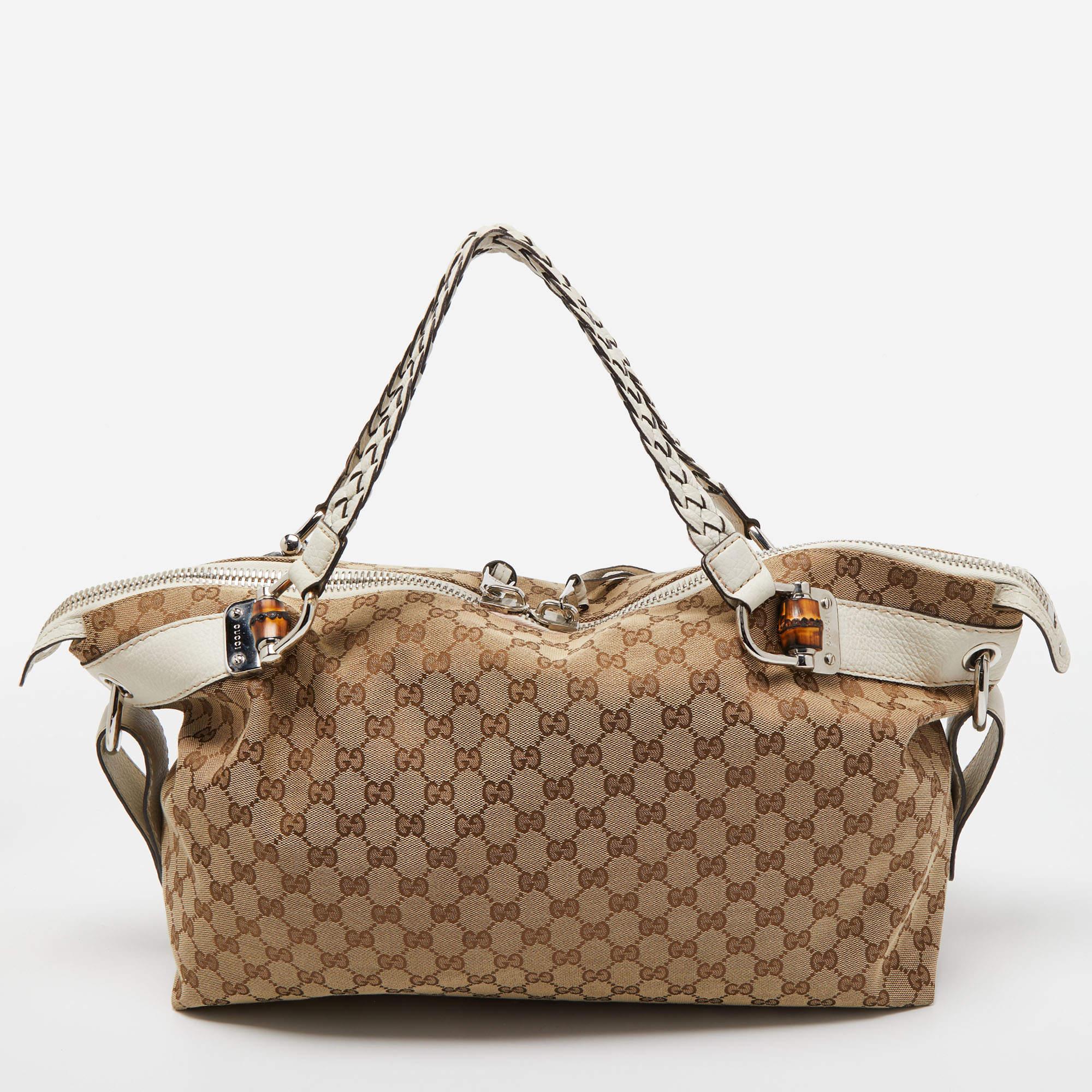 Designed in the iconic and an instantly recognisable GG canvas from Gucci, this Bamboo Bar travel bag is a must have for when you travel. Inject a dose of luxury and effortless style with this travel bag featuring leather accents and two braided top