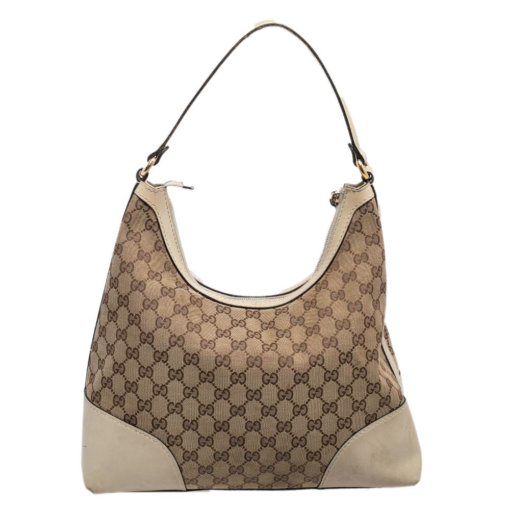 Choose this Gucci hobo to complement your effortless everyday look. The bag is crafted from GG canvas as well as leather and features a single handle and gold-tone hardware. The canvas-lined interior will dutifully hold all your daily essentials.