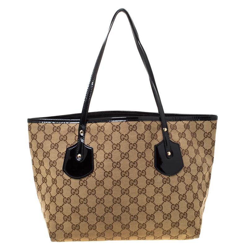 Be super stylish with this Gucci Jolie tote which has been crafted in beige monogrammed canvas. The exterior features some cool bag charms and patent leather handles. The open interior is roomy and lined in fabric and has a zippered