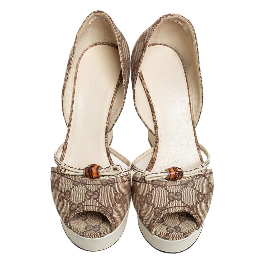You are sure to receive a luxurious style and comfort with these sandals by Gucci. They come crafted from GG canvas with a d'Orsay cut topline and bamboo detailing on the uppers. Peep toes, platforms, and 11.5 cm wedge heel complete this lovely