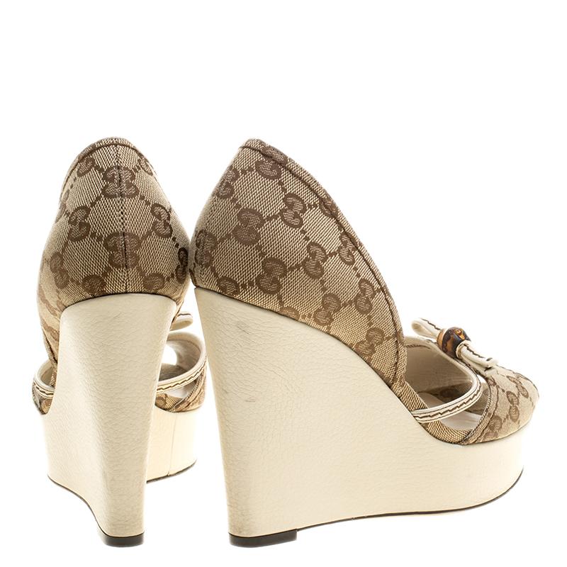 You are sure to receive luxury and style with these sandals by Gucci. They come crafted from GG canvas with a d'Orsay cut topline and bamboo detailing on the uppers. Peep toes and 12 cm wedges complete this lovely pair.

Includes: The Luxury Closet