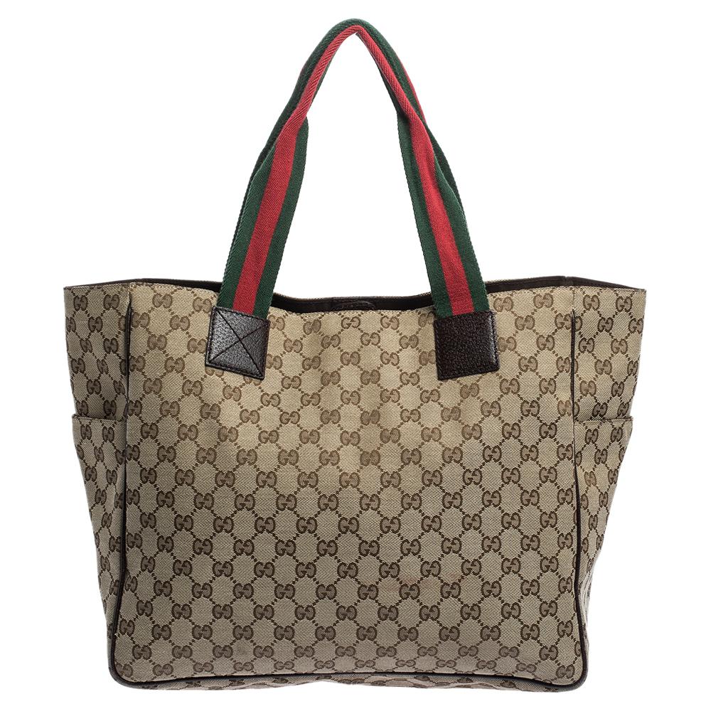 Gucci presents the perfect bag for all occasions, be it work or shopping. The tote is crafted from the signature GG coated canvas. The beige bag is complemented by two pockets on the front and double Web handles. This is a must-have in your closet.
