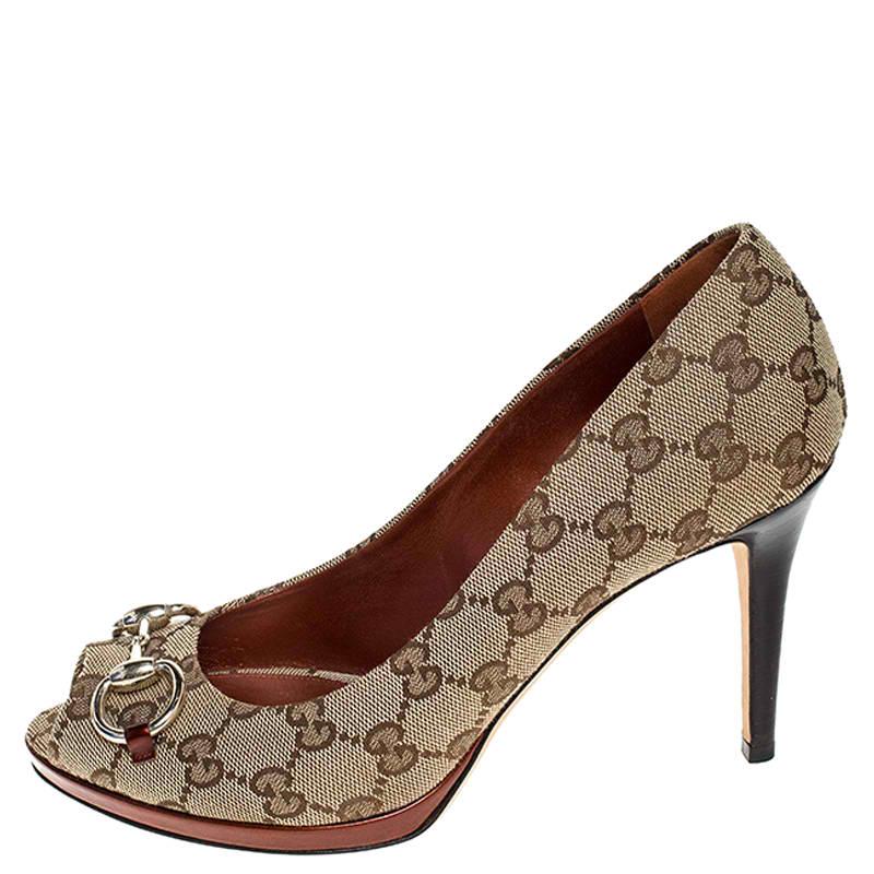 These beige Gucci peep-toe pumps speak classic style. Crafted in signature GG canvas, the pumps feature horsebit detailing in gold-tone. Pair these pumps with your favorite formal outfit for a high style at work!

Includes: Original Dustbag

