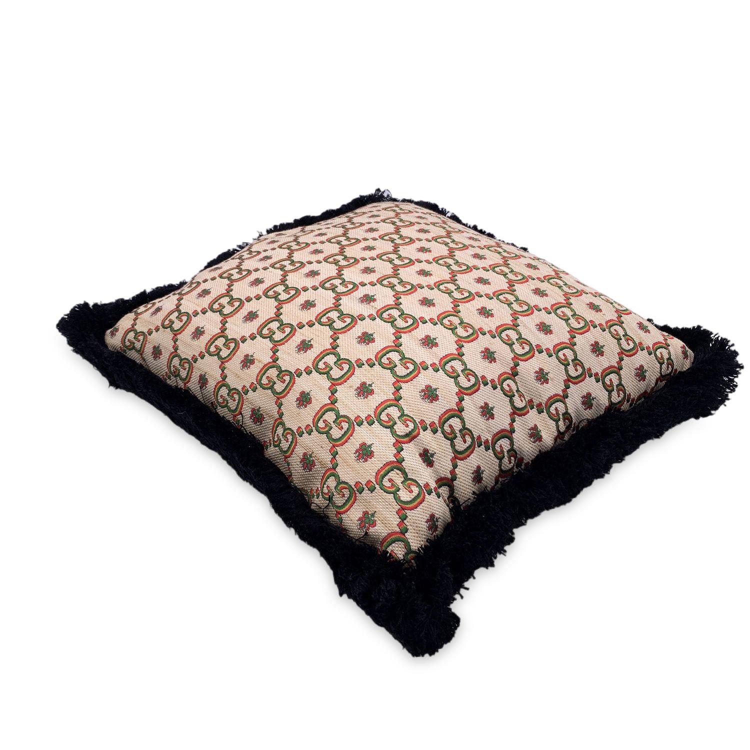 Beutiful GUCCI Cushion in beige and yellow with all-over multicolour embroidered GG logo pattern. Black frayed edges. Model with Gucci label sewn on the back. Front part: 44% Polyester, 32% Tussah Silk, 9% Silk, 15% Cotton. Back part: 43% Viscose,