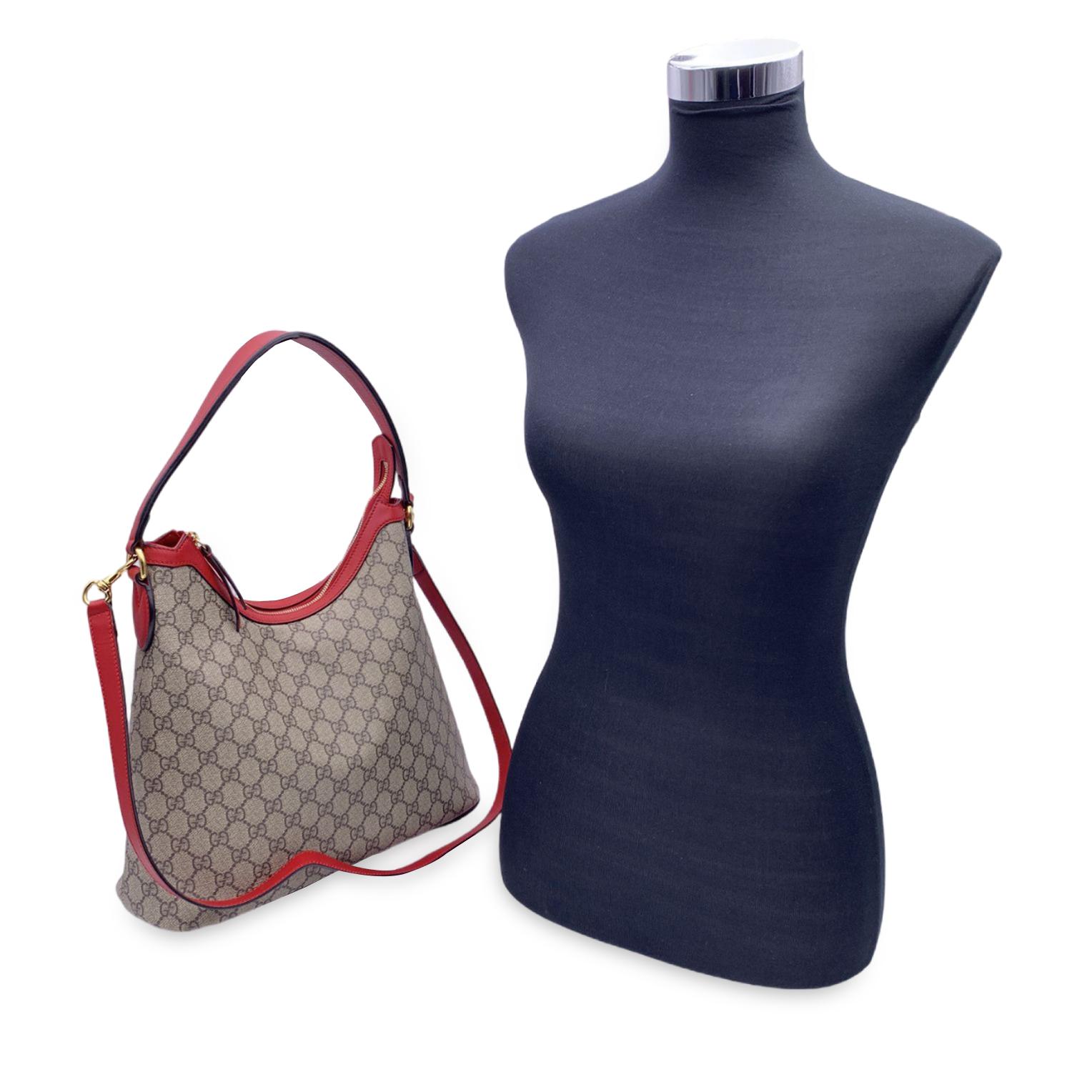 This beautiful Bag will come with a Certificate of Authenticity provided by Entrupy. The certificate will be provided at no further cost.

Beautiful Gucci tote hobo bag crafted in GG Supreme coated canvas, featuring red leather shoulder straps and