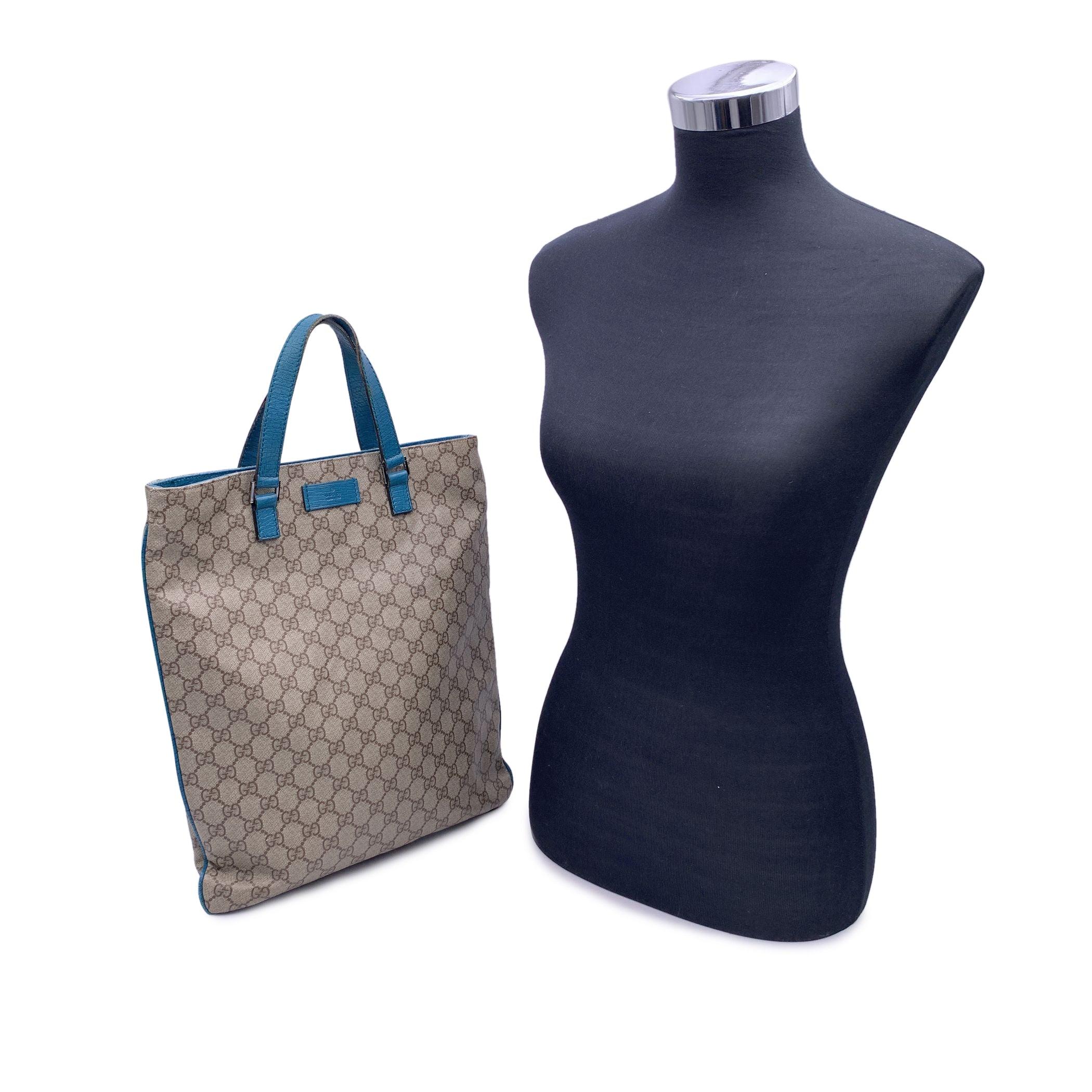 Gucci beige monogram canvas tote shopping bag with teal leather trim and handles. Leather logo patch on the front. Magnetic button closure on top. Fabric lining. 1 side zip pocket inside. 'Gucci - made in Italy' tag (with serial number on its