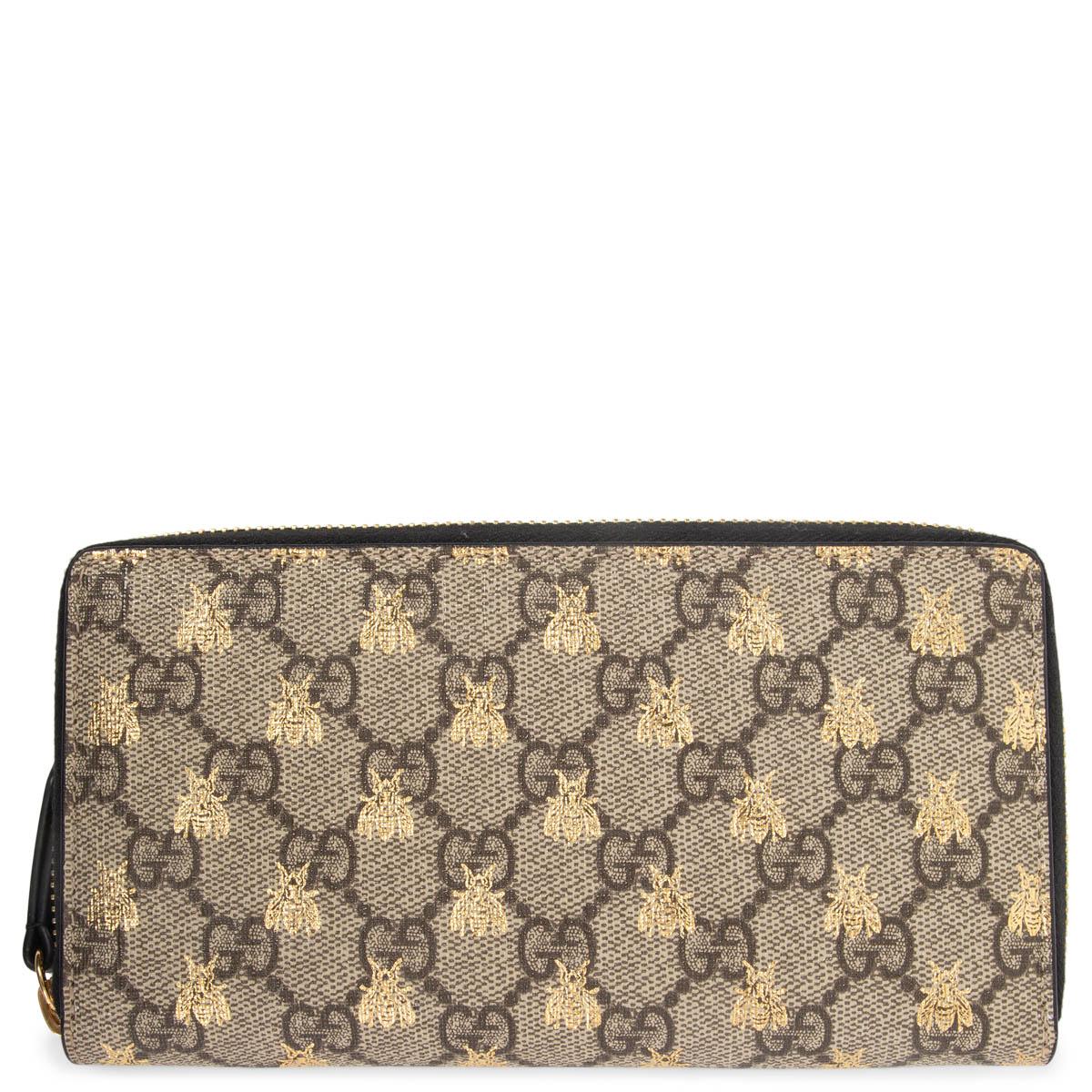 100% authentic Gucci Bees zip around wallet in beige and ebony monogram GG Supreme canvas with metalic gold bee print. Lined in black leather with 12 credit card slots, a zip pocket for coins and three full-size compartements. Has been carried and