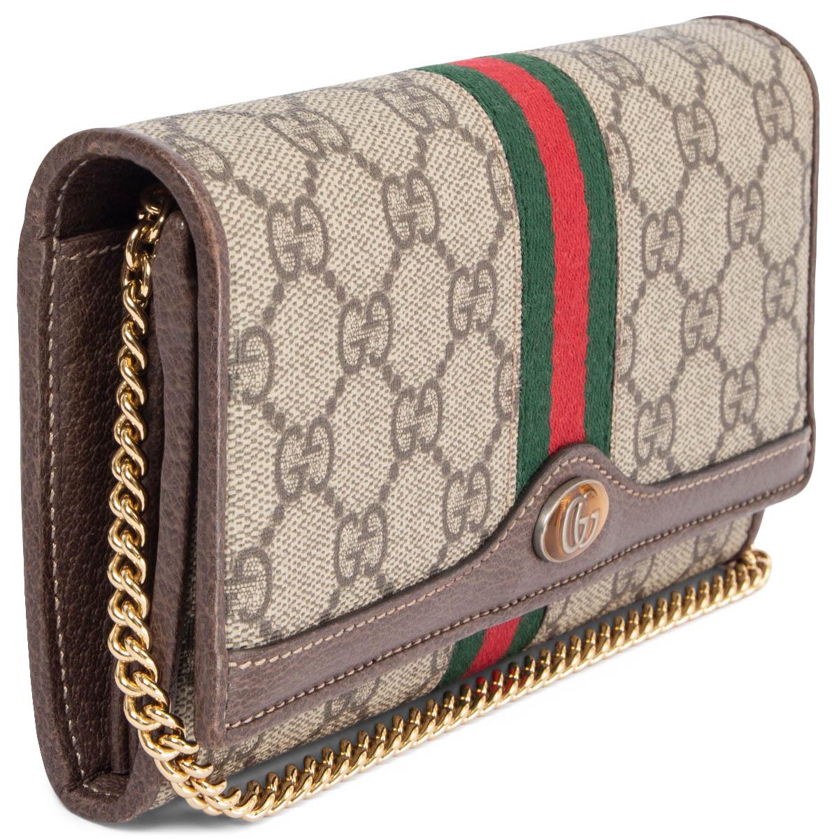 100% authentic Gucci Ophidia GG chain wallet in beige and ebony Supreme canvas with signature Web stripe in green and red cotton and brown leather trim. Oval gold-tone enamel detail with metal Double G. The wallet has a compartment construction and