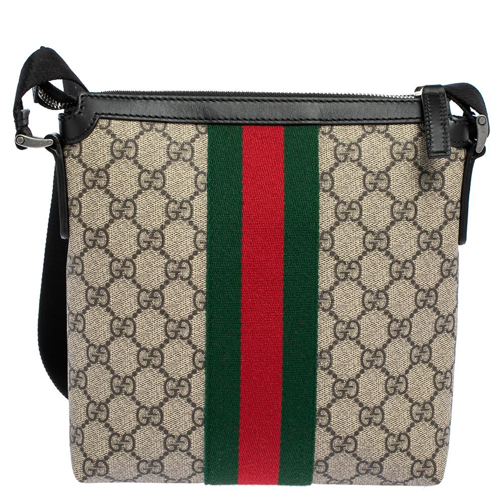 Add to your look by accessorizing with this Gucci messenger bag. Designed expertly, this bag features a GG Supreme coated canvas body that is enhanced with leather trims. The bag flaunts the signature web detailing running through the center. It is