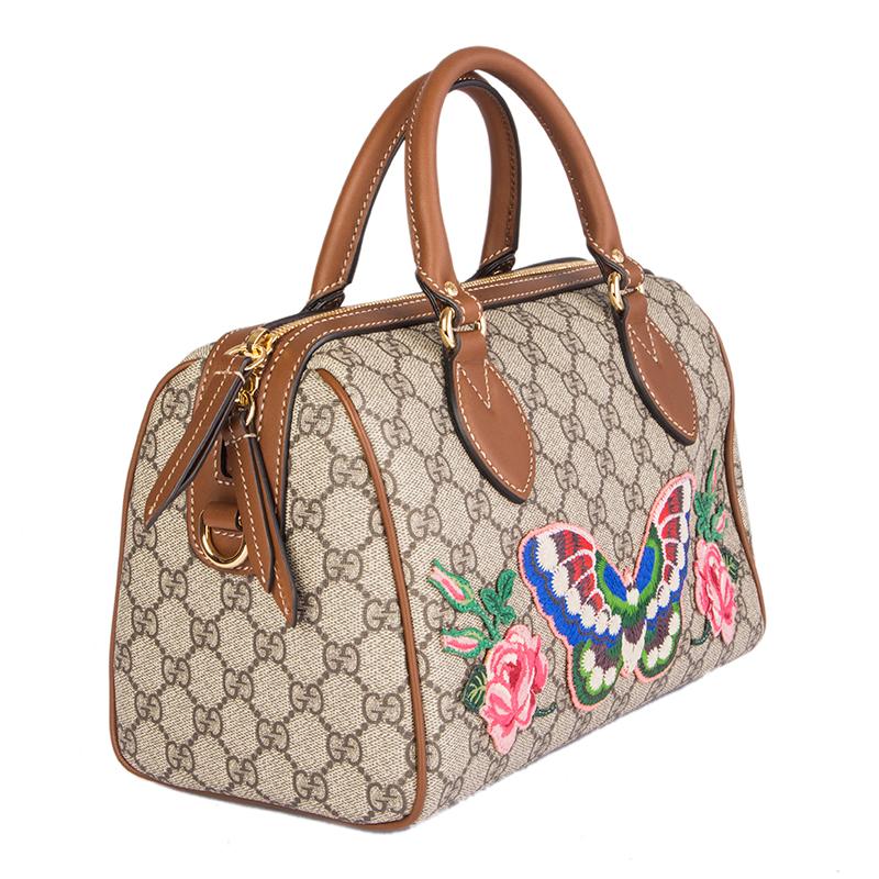 Gucci 'Butterfly Embroidered Linea A Boston' bag in brown GG Supreme canvas with detail in brown leather. This bag was only availabe in Japan. Closes with a two-way zipper on top. Lined in pale pink suede with two open pockets against the front and