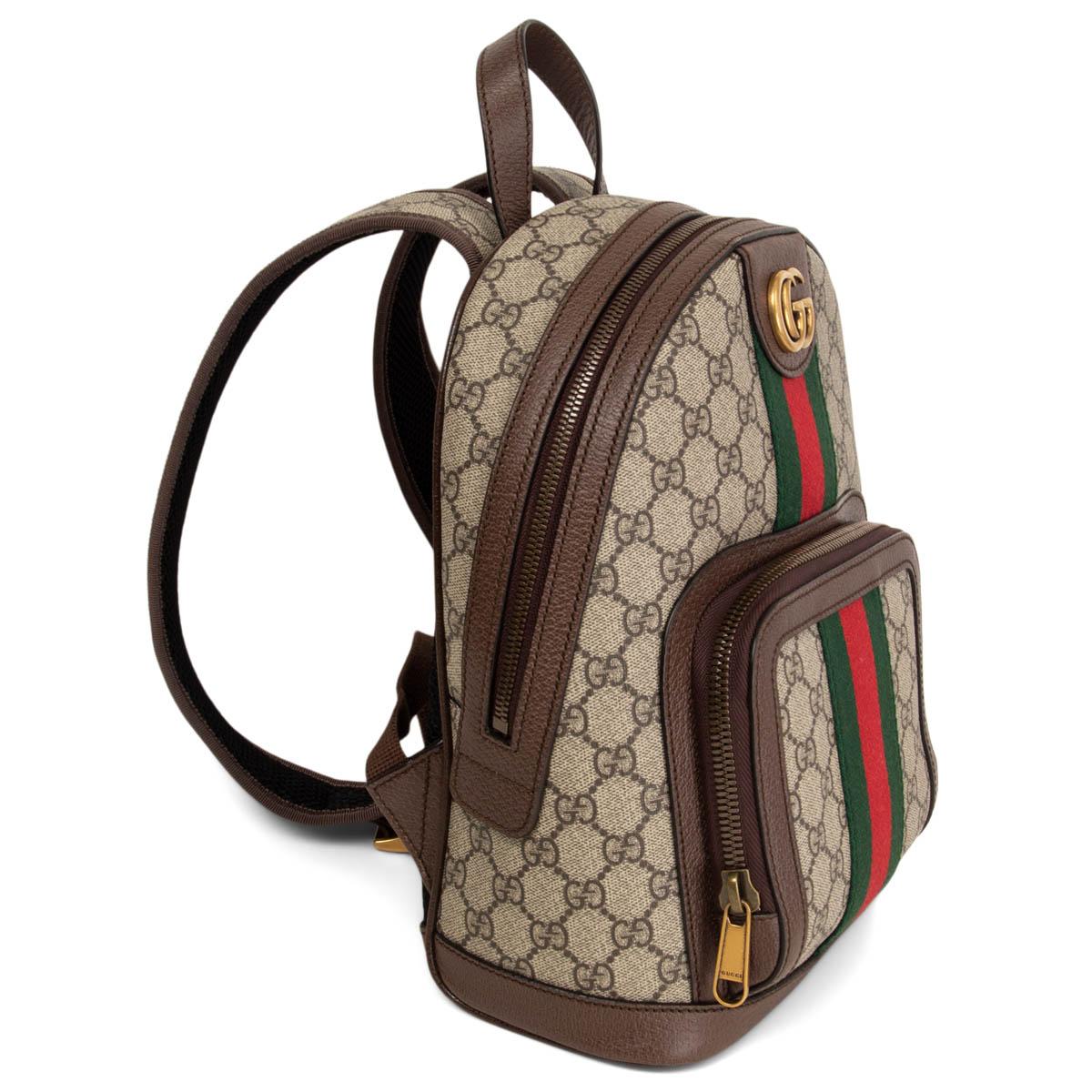 100% authentic Gucci Ophidia Small backpack in beige and ebony GG Supreme canvas and brown leather trim. Featuring green and red web stripe and double G in metal. Outside zipper pocket and adjustable strap. Lined in canvas with smartphone pockets