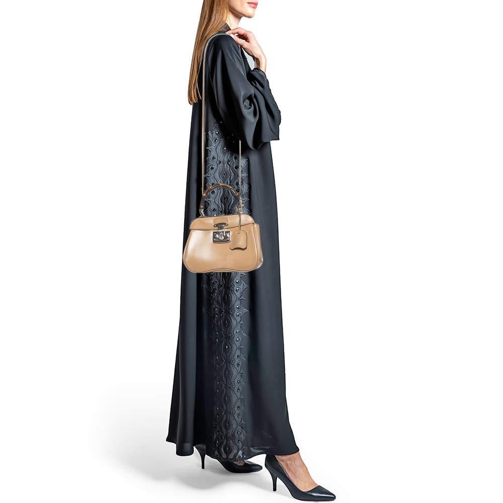 Handbags as fabulous as this one are hard to come by. Crafted from leather, this stunning number features a lady lock, a leather key holder and a detachable shoulder strap. The spacious suede interior houses a zipped compartment that will safely