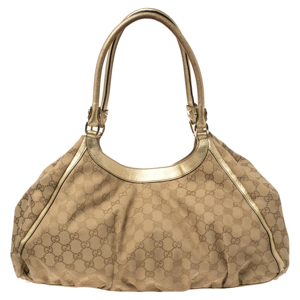 Gucci brings to you this amazing D Ring bag that is a timeless keep. Made in Italy, it is crafted from GG canvas as well as leather and features two handles. The bag has gold-tone hardware and a fabric-lined interior with enough space to hold all