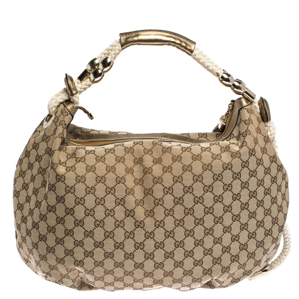 A handbag should not only be good-looking but also functional, just like this pretty Acapulco hobo from Gucci. Crafted from the signature GG canvas in Italy, this gorgeous beige number comes with a lovely knit strap embellished with gold-tone