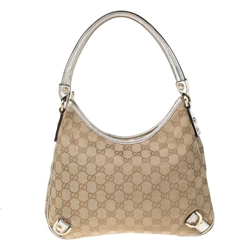 Gucci brings to you this amazing D Ring hobo that is smart and modern. Made in Italy, this beige and gold hobo is crafted from classic GG canvas and features a single top handle. The top zipper reveals a fabric lined interior with enough space to