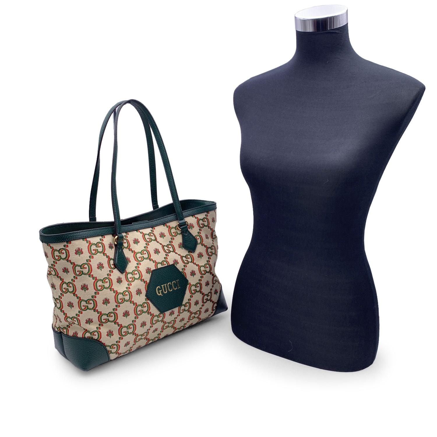 Gucci 100 Ophidia tote bag designed In honor of the Centennial of the brand, from the The Gucci Aria collection. Crafted in beige jacquard canvas with green leather trim and shoulder straps. Gold metal hardware. Leather detail on the front with