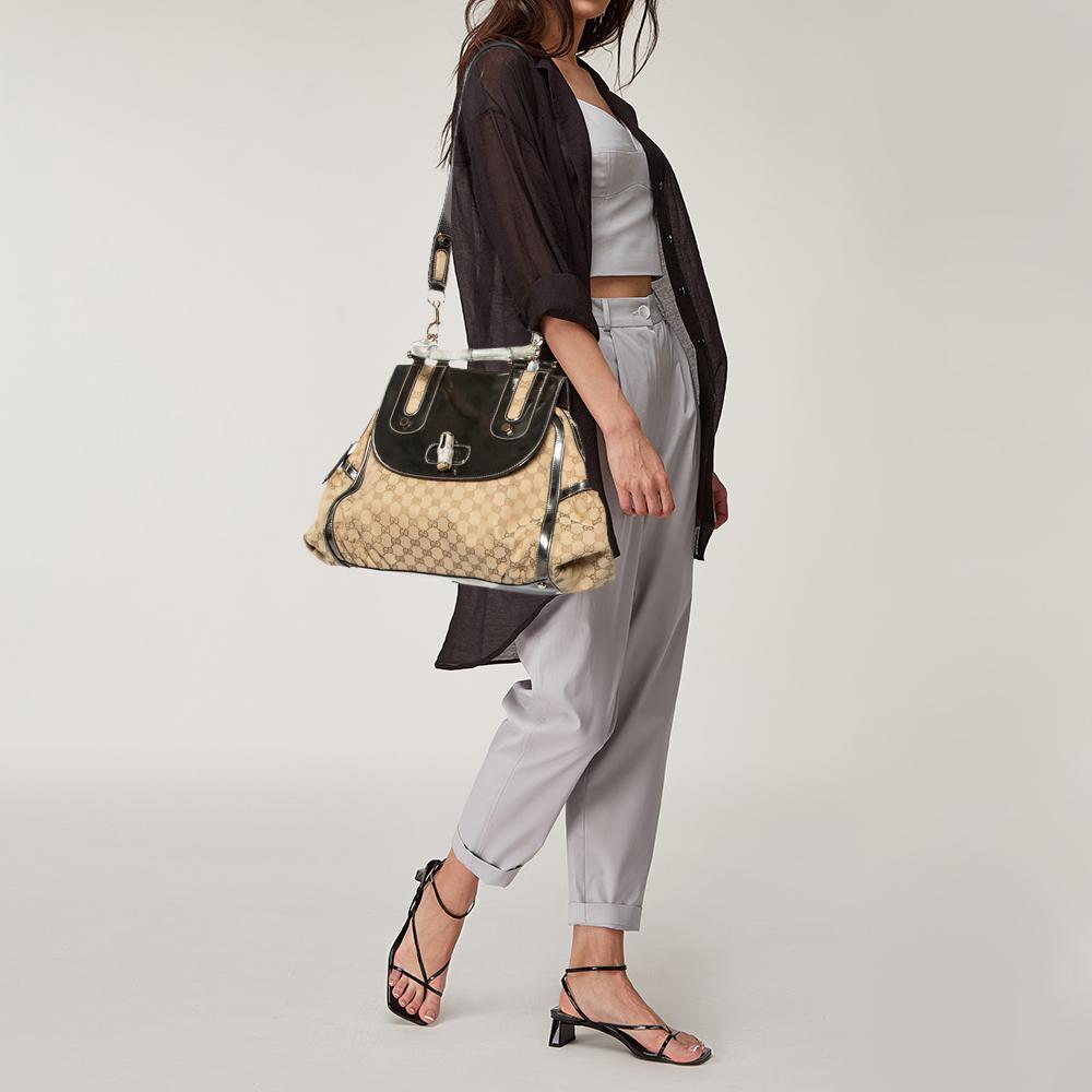 Gucci brings to you this amazing bag that is smart and very modern. Made in Italy, this beige & grey bag is crafted from canvas & leather and styled with a bamboo handle. The bamboo turn-lock reveals a fabric-lined interior with enough space to hold