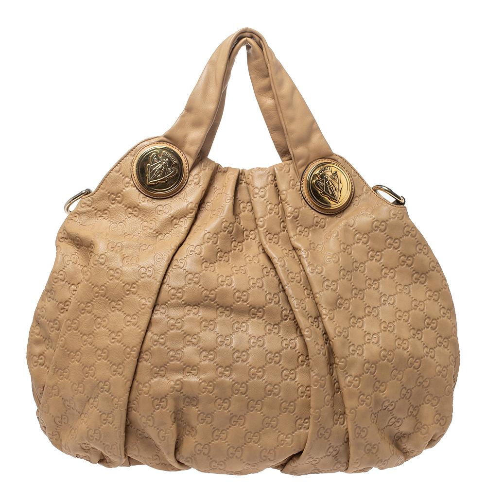 This Gucci hobo is built for everyday use. Crafted from Guccissima leather, it has a beige exterior and two handles for you to easily parade it. The fabric insides are sized well and the hobo is complete with the signature emblems.

Includes: