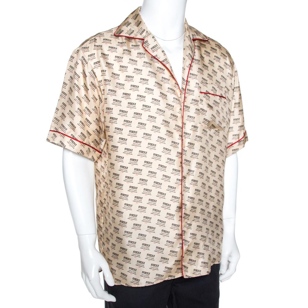 Walk with confidence and abundant style when you don this one of a kind bowling shirt from Gucci. Crafted from pure silk, it flaunts a cream hue with an 'invite stamp' print throughout. The shirt is styled with a collar, a front pocket, short