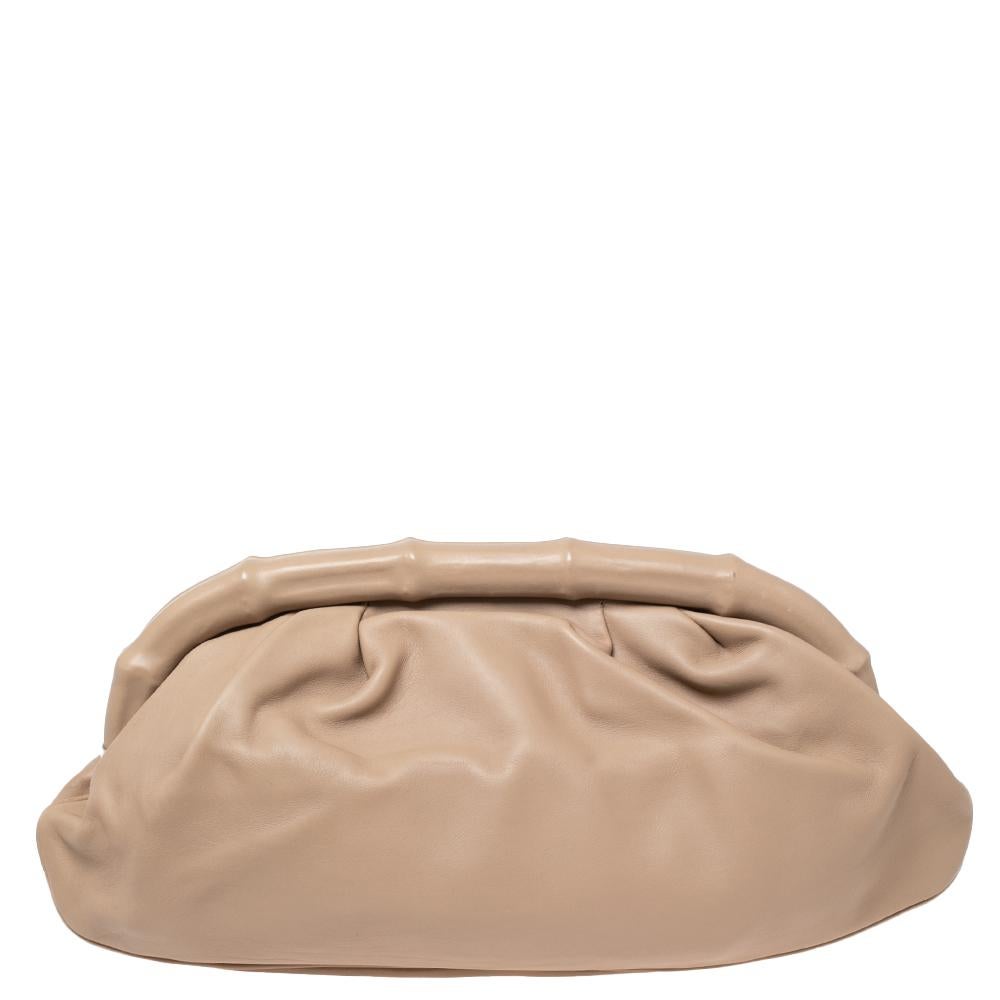 This beige clutch from Gucci has been meticulously crafted from leather and the bamboo-like frame top opens to reveal a fabric-lined interior to hold all your party essentials. This piece totally deserves a place in your closet.

Includes: Original