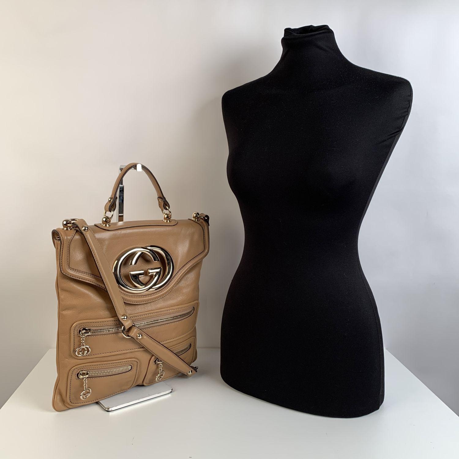 We offer Certificate of Authenticity provided by Entrupy for this item at no further cost.

Gucci beige leather 'Britt' Messenger Bag with a big Gucci logo on the front, in gold-tone metal. It features 3 three zip pockets with GG logo zipper pulls