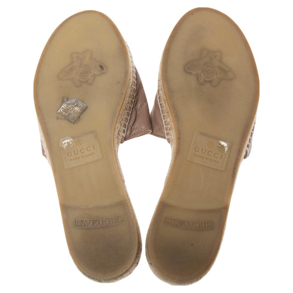 Presented by the House of Gucci, these GG Marmont Pilar slides will adorn your feet with their chic aesthetic and signature beauty. They are crafted using beige leather, with a gold-toned GG motif placed on the upper. They have espadrilles and are