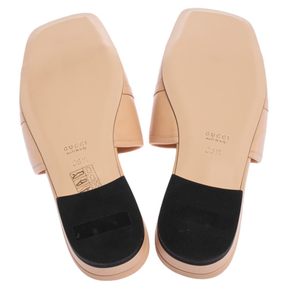 Gucci's caliber to combine its archival codes with modern silhouettes is evident in these flat slides. They have been crafted from beige leather and designed with broad straps topped with the iconic Horsebit accent in gold-tone.

Includes: Original