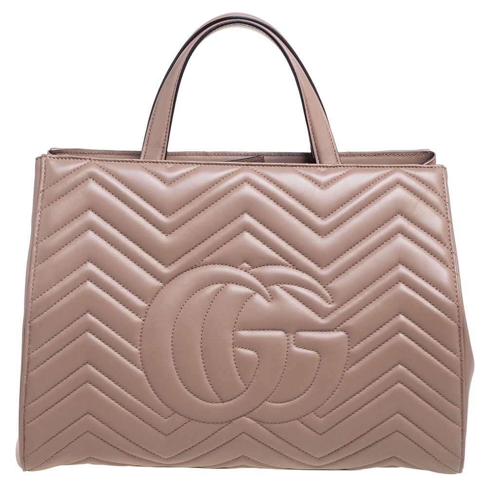The Marmont tote has been exquisitely crafted from matelassé leather and equipped with a well-sized Alcantara interior. On the front, there is a gold-tone GG logo and two handles and a detachable shoulder strap are provided for you to swing the bag.