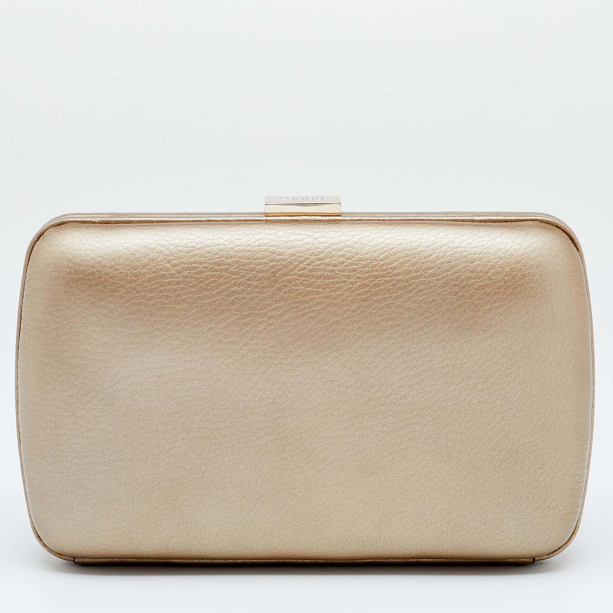 This clutch from Gucci has an appealing design, perfect to complement an evening dress or a party ensemble. Crafted from leather and gold-tone metal, the creation has a front GG logo, a well-lined interior, and a chain handle.

Includes: Original