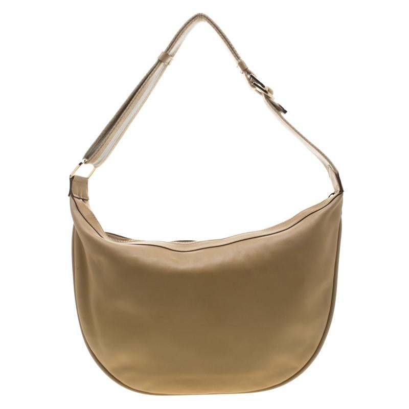 This Gucci bag is beautifully designed and is luxuriously crafted from leather. The bag comes with a web strap and a spacious nylon interior that is secured by a zip-top closure. This hobo will instantly elevate the look of any outfit.

Includes: