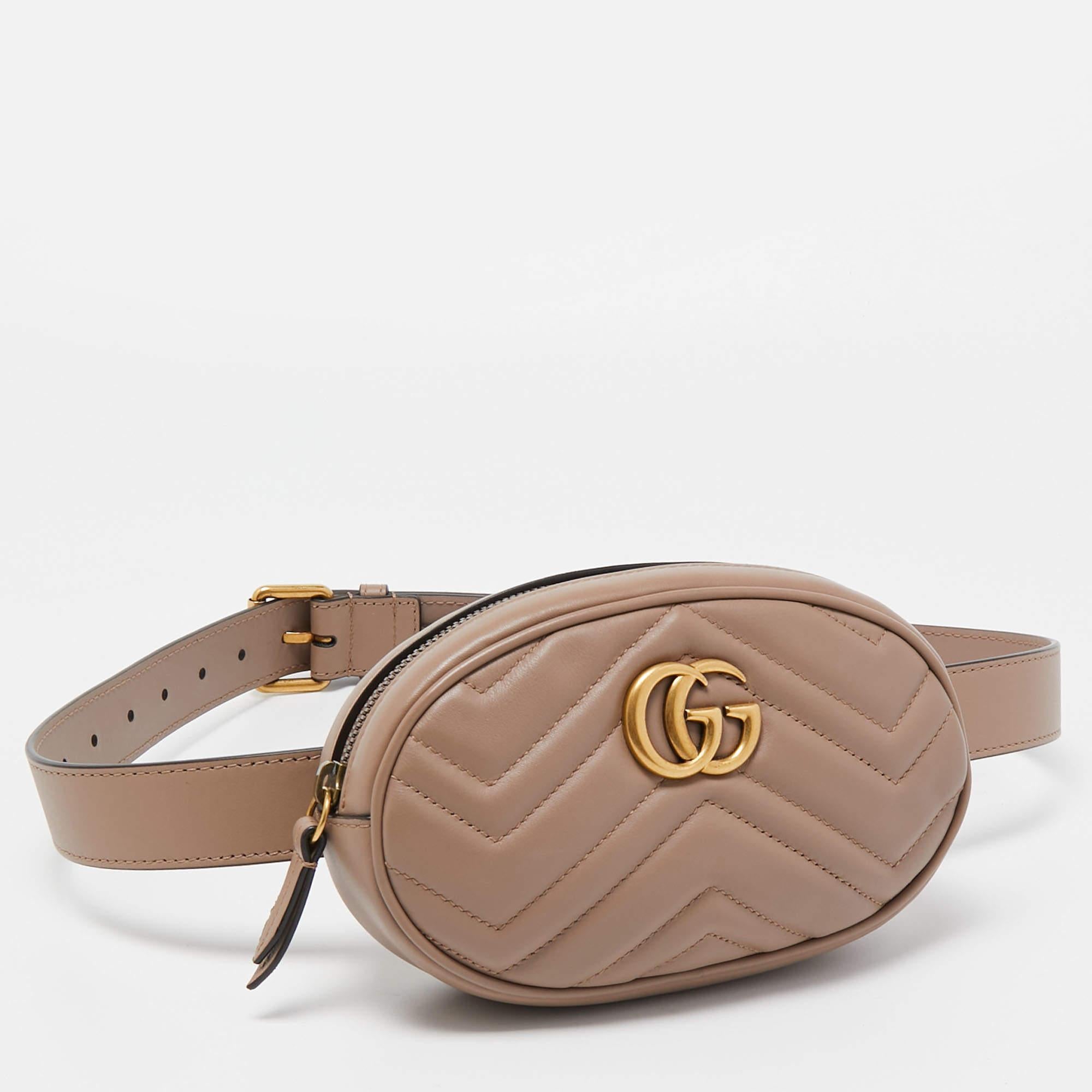 The Gucci Marmont bag has been exquisitely crafted from leather and is equipped with an Alcantara interior. On the front, there is the GG logo in gold-tone metal and the leather belt is provided for you to style the piece as a waist bag.


