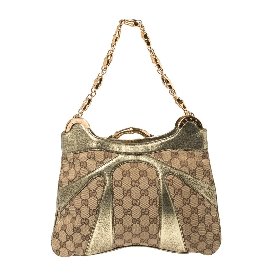 One look at this shoulder bag from Gucci, and you will know right away why it deserves to in your closet. Crafted from GG canvas and styled with metallic leather, this piece is held by chain handles featuring bamboo accents, and the front features a